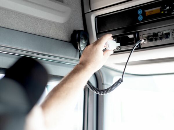 Truck driver inserts download key TachoKEY into Smart Tachograph